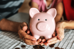 Family and pink piggy bank