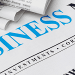 Newspaper with a blue and black heading saying Business News